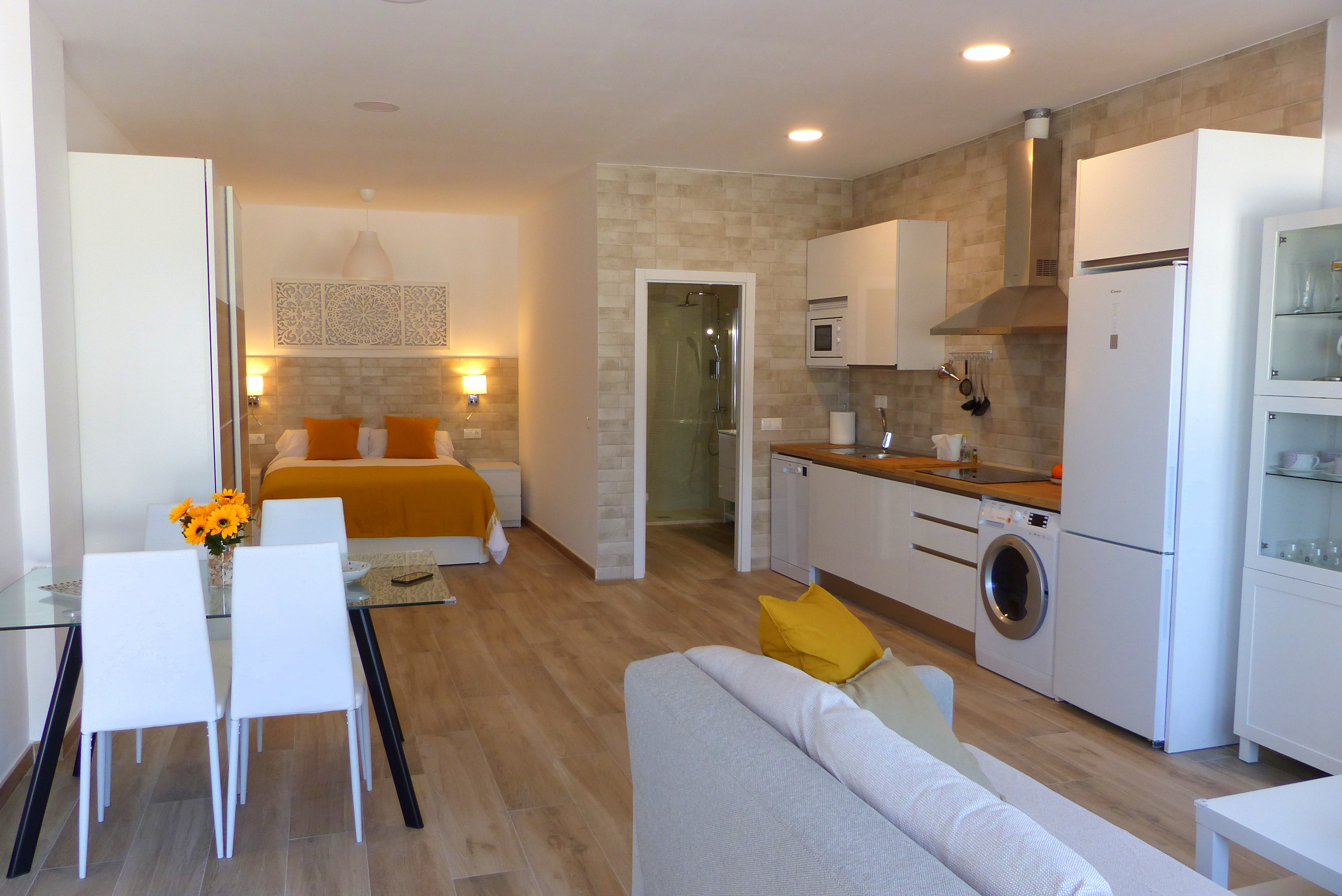 Interior view of beachfront loft apartment in Benalmádena showing living room, kitchen and open space